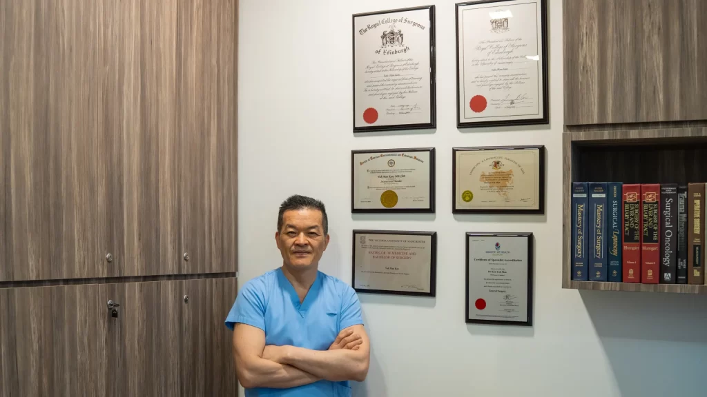 Dr Kan Yuk Man, Senior Consultant Surgeon, in surgical scrubs at KYM Surgery